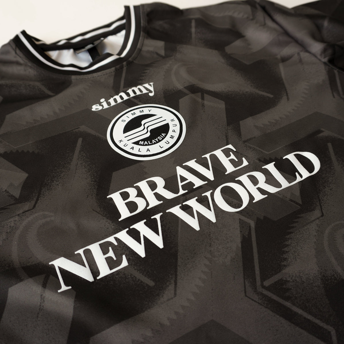 SIMMY black oversized jersey featuring Brave New World text and a circular Kuala Lumpur logo graphic