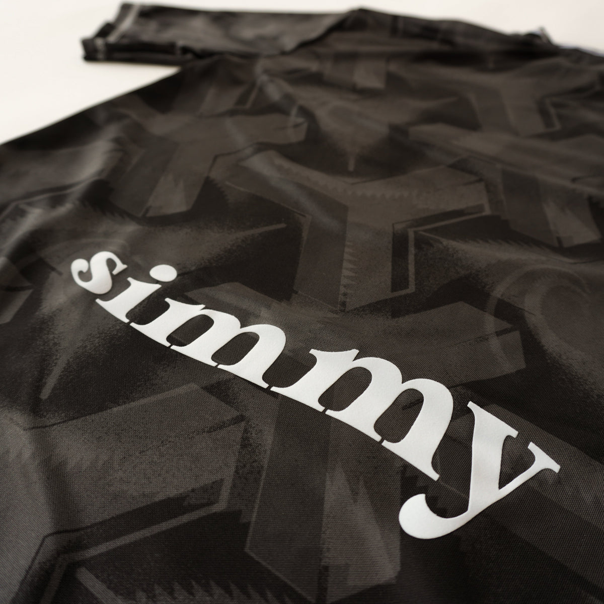 SIMMY Brave New World oversized black jersey featuring a bold all-over graphic pattern and white brand logo text.